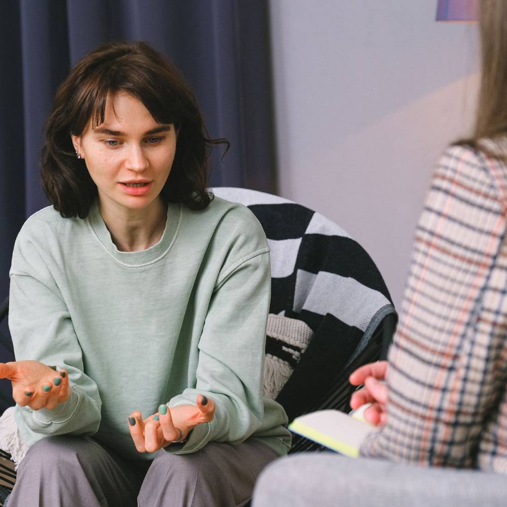 Woman talking to her therapist during a counseling session.