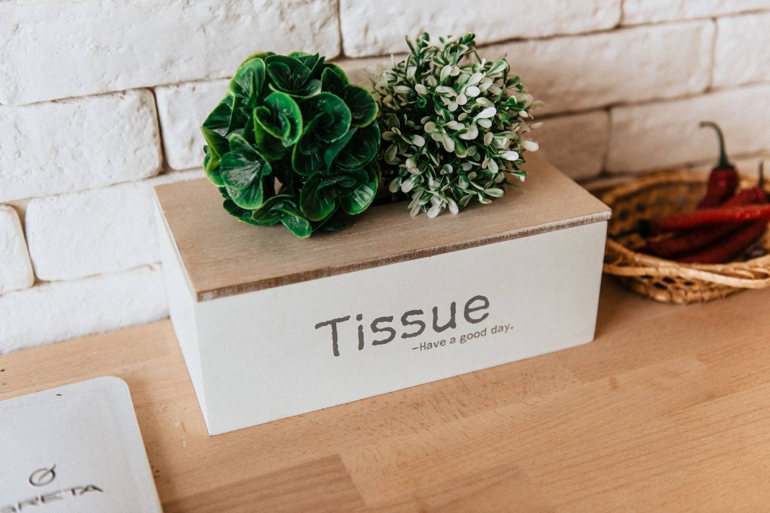 Decorative wooden tissue box on a tabletop in a modern room.